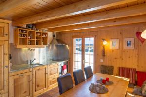 a kitchen with a table and a dining room at Chalet Pierre Blanche in Nendaz