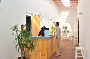a man standing at a counter in an office at El Bahía Algeciras in Algeciras