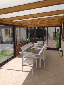 a dining table and chairs on a patio at La salicorne in Pendé
