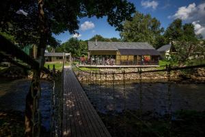 a building with a fence next to a river at Lontova puhkemaja in Kunda