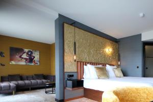 a bedroom with a large bed and a large window at Alexander Hotel in Noordwijk aan Zee