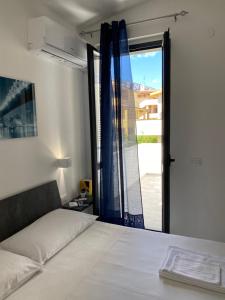 A bed or beds in a room at Cala Gonone - Casa del Mirto