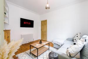 a living room with a couch and a table at Churton House in Chester