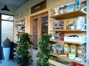 a room with wooden shelves with jars and plants at Riparo di Masseria Urbana in Crispiano
