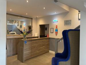 a waiting room with a counter and a mirror at The Craigie Hotel in Penicuik