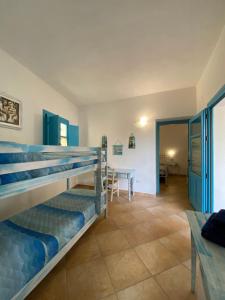 a bedroom with a bunk bed and a dining room at Centu Concas in Muravera