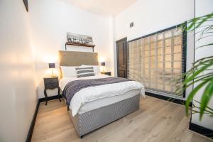 Postel nebo postele na pokoji v ubytování Proform Property Apartments