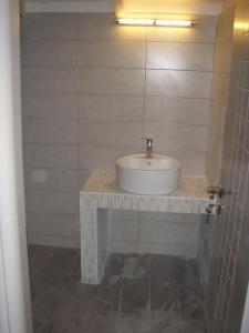 a bathroom with a white sink and a mirror at Katerina Lefkada in Vasiliki