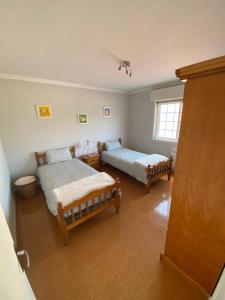 a bedroom with two beds and a window at A de Barreiro in Pontevedra