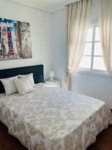 um quarto com uma cama grande e uma janela em Duplex Penthouse Panoramic Del Atlantico em Adeje