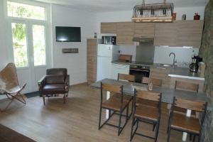 a kitchen with a table and chairs in a room at Résidence Perce Neige in Luz-Saint-Sauveur +47 photos