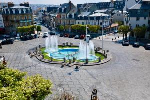 a fountain in the middle of a city at Fontaines de Morny in Deauville