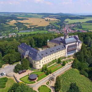 an aerial view of a large building in the countryside at Chateau Zbiroh in Zbiroh