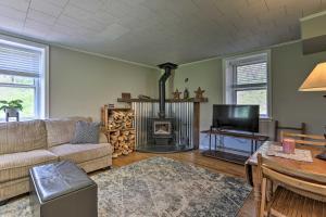 a living room with a couch and a fireplace at Idyllic Hellertown Cottage with Patio and Fire Pit! in Bethlehem