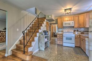 a kitchen with a spiral staircase in a house at Idyllic Hellertown Cottage with Patio and Fire Pit! in Bethlehem