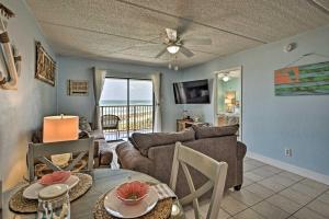 a living room with a couch and a table at Oceanfront Ormond Beach Getaway with Balcony! in Ormond Beach