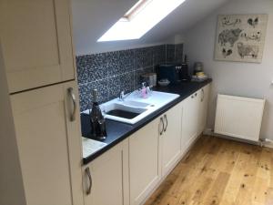a kitchen with a sink and a counter top at Burn View in Stronachlachar