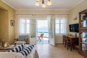 a living room with a view of the ocean at Villa Blue Sky in Tripití