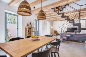 a dining room with a table and chairs and a staircase at Casa Santa Maria Vacation House in Mali Lošinj