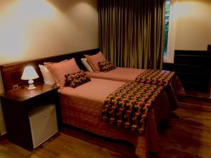 Un pat sau paturi într-o cameră la Pousada Serra Paradiso