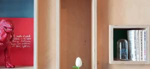 a book shelf with books and a red statue at OYO rooms in Kortrijk +15 photos