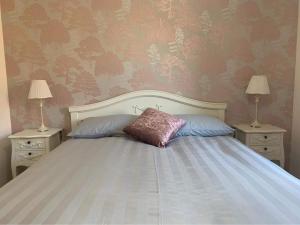 a bedroom with a bed with two tables and two lamps at Ard Na Mara Self Catering Isle of Mull in Dervaig