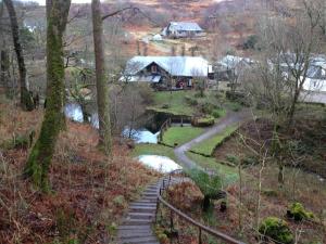 a stone path leading to a house and a river at Ard Na Mara Self Catering Isle of Mull in Dervaig