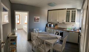 a kitchen with a table and a dining room at Gasthaus Hafenblick in Tönning