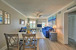 a dining room and living room with a table and chairs at Soothing Oceanview Condo with Direct Beach Access! in Atlantic Beach