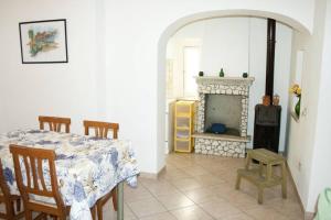 a dining room with a table and a fireplace at La casa di Matilde in Rodi Garganico