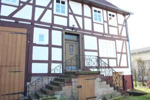 a house with a door and stairs in front of it at Ferienhaus 1893 Frielendorf in Frielendorf