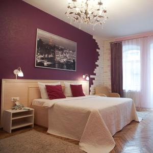 a bedroom with a large bed with purple walls at Pro Счастье in Saint Petersburg