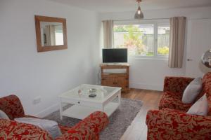 a living room with two couches and a tv at Berwicks House - NEC & Airport - Stylish 3-bed house with garden in Birmingham