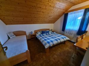 a bedroom with a bed and a window with blue curtains at Apartment Charlie in Seliste Dreznicko