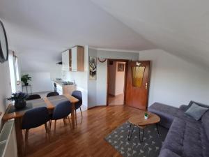 a living room with a blue couch and a table at Apartment Charlie in Seliste Dreznicko +12 photos