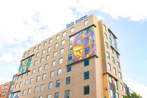 a building with a painting on the side of it at ibis budget Bogota Marly in Bogotá