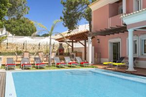 a villa with a swimming pool and patio furniture at Villa Falesia Mar by Villa Plus in Olhos de Água
