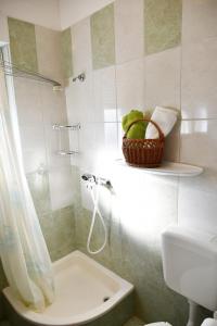 a bathroom with a shower and a toilet and a sink at Apartments Novotny in Rab +25 photos