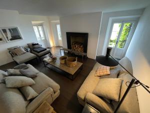 a living room with two couches and a fireplace at Pescallo Apartments in Bellagio