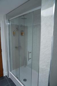 a shower with a glass door in a bathroom at Low Haven in Keswick +14 photos