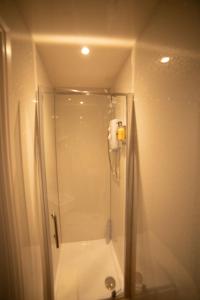 a shower with a glass door in a bathroom at Low Haven in Keswick
