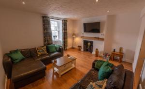 a living room with a couch and a table at Low Haven in Keswick
