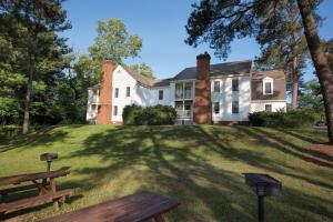 a house on a hill with a bench in the yard at Club Wyndham Patriots Place in Williamsburg