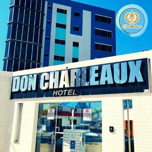 a sign on top of a building with a hotel at Don Charleaux Hotel in Aparecida