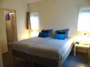 Кровать или кровати в номере Vakantiehuis Zee in zicht