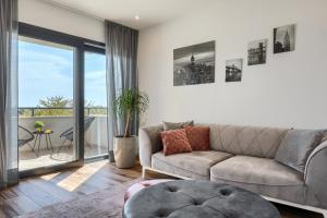 a living room with a couch and a balcony at Belvedere Holidays in Novigrad Istria