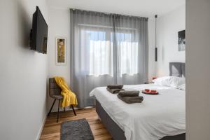 a bedroom with a bed with towels on it at Belvedere Holidays in Novigrad Istria +84 photos