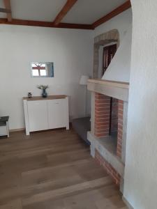 a living room with a brick fireplace and a table at Apartment Mamut in Premantura