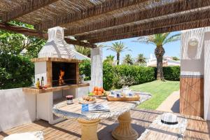 a patio with a table and an outdoor oven at Villa Carianne by Villa Plus in Son Carrio