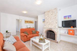 a living room with a couch and a fireplace at Villa Carianne by Villa Plus in Son Carrio
